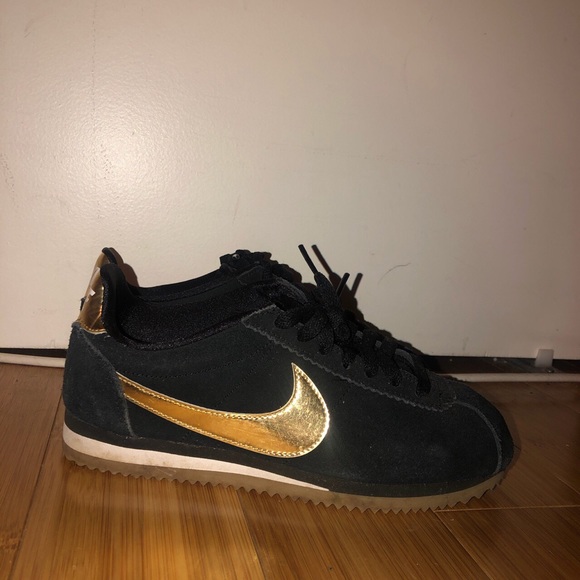 black nike cortez with gold swoosh